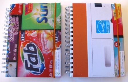 Close up of recycled notebooks made from EECA campaign posters.